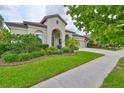 Charming single-story home with well-manicured landscaping and a welcoming entryway at 6016 Shadowlake Dr, Apollo Beach, FL 33572