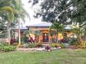 Inviting front yard with lush tropical landscaping and a double-door entry at 6801 S Sparkman St, Tampa, FL 33616