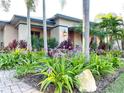 Lush landscaping with vibrant plants and a stone-accented walkway leading to the house at 6801 S Sparkman St, Tampa, FL 33616