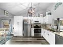 Bright kitchen featuring sleek white cabinetry, stainless steel appliances, and modern decor at 7741 Forest Trl # 6, Port Richey, FL 34668