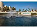 Harbour Side sign beside a pond with a fountain, framed by palm trees and community buildings at 7932 Sailboat Key S Blvd # 506, South Pasadena, FL 33707