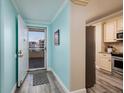 Bright foyer with an open door leading to a balcony and a glimpse of the kitchen at 7932 Sailboat Key S Blvd # 506, South Pasadena, FL 33707