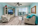 Living room with light-colored walls, modern furniture, and a balcony with water view at 7932 Sailboat Key S Blvd # 506, South Pasadena, FL 33707