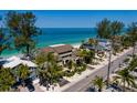 Exterior view of multi-level beachfront property with lush landscaping and gulf views at 8226 W Gulf Blvd # 2, Treasure Island, FL 33706