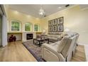 Cozy living room with fireplace, beautiful windows, and neutral color scheme at 8444 Shenandoah Run, Wesley Chapel, FL 33544