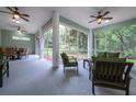 Large screened patio with comfortable seating and peaceful views of the backyard at 8444 Shenandoah Run, Wesley Chapel, FL 33544