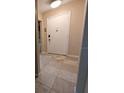 Condo entryway with tiled floor, white front door and decor at 8765 Bardmoor Blvd # 108, Seminole, FL 33777