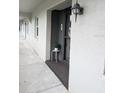 Cozy condo entryway featuring textured walls and updated lighting fixture at 8765 Bardmoor Blvd # 108, Seminole, FL 33777