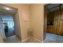 Condo hallway with tiled floor leading to living area and kitchen at 8765 Bardmoor Blvd # 108, Seminole, FL 33777