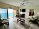 Bright and inviting living room with amazing ocean views and comfortable wicker furniture at 880 Mandalay Ave # C1103, Clearwater Beach, FL 33767