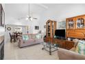 Spacious living room with tile flooring, comfortable seating, fireplace, and views into the dining area at 10213 Westport Ct, Tampa, FL 33615