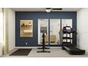 Well-equipped exercise room featuring a treadmill, stationary bike, and mirrored wall at 11836 Blue Diamond Trl, Parrish, FL 34219