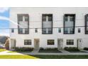 Modern townhome exterior with eye-catching window frames and lush landscaping at 1330 W Gray St # 2, Tampa, FL 33606