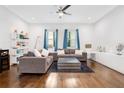 Bright living room featuring hardwood floors, recessed lighting, and two comfortable sofas with large windows at 1330 W Gray St # 2, Tampa, FL 33606