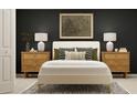 Modern bedroom featuring a bed with decorative pillows, matching nightstands and neutral carpet at 13526 White Gold Run, Parrish, FL 34219