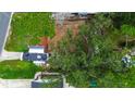 An aerial view of the home's roof and surrounding landscaping with mature trees at 1726 Massachusetts Ne Ave, St Petersburg, FL 33703