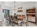 Bright dining room featuring a large wooden table, stylish chairs, and views of the outdoors at 1741 Beaconsfield Dr, Wesley Chapel, FL 33543