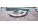 Outdoor pool area featuring a brick paver deck and built-in jacuzzi tub at 1931 Oak Ridge Ct, Clearwater, FL 33759