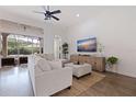 Bright Living room with hardwood floors, sliding glass doors and a large entertainment center at 1936 Floresta View Dr, Tampa, FL 33618
