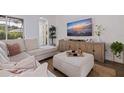 Living room area featuring a modern couch, textured rug, and a large television at 1936 Floresta View Dr, Tampa, FL 33618