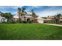 Two-story home with manicured lawn and mature landscaping and a two car garage at 1988 Carolina Ne Cir, St Petersburg, FL 33703