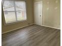 Bedroom featuring hardwood-look floors and a sunlit window at 2219 Durham St, Tampa, FL 33605