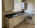 Functional kitchen featuring basic appliances and ample cabinet space at 2219 Durham St, Tampa, FL 33605