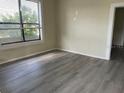 Bright living room featuring large windows and wood-look floors at 2219 Durham St, Tampa, FL 33605