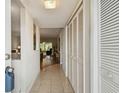 Inviting hallway with tiled floor, coat closet, and view of the living room at 2261 Swedish Dr # 47, Clearwater, FL 33763