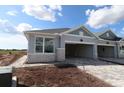 Charming home featuring stone accents, a spacious garage, and a well-lit exterior at 2824 Marrakesh Ln, Sarasota, FL 34234
