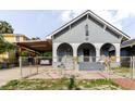 Charming bungalow-style home with a covered carport and front porch arches at 2825 N Taliaferro N Ave, Tampa, FL 33602