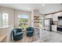 Inviting living space with bright windows, casual seating, hardwood floors, and direct access to the kitchen at 3147 Oyster Bayou Way, Clearwater, FL 33759