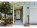 Welcoming front entrance with a stone accent wall and a decorative door at 39243 6Th Ave, Zephyrhills, FL 33542