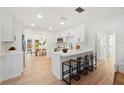 Stylish kitchen with white cabinets, a breakfast bar, and sleek countertops at 4012 W Pearl Ave, Tampa, FL 33611