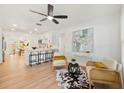 Bright living room with modern furnishings, light wood floors, and ample natural light at 4012 W Pearl Ave, Tampa, FL 33611
