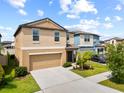Charming home with lush lawn, showcasing neutral tones and an attached two-car garage at 4403 Eternal Prince, Sun City Center, FL 33573