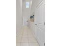 Bright foyer with tile flooring, a staircase, and modern wall art at 4403 Eternal Prince, Sun City Center, FL 33573