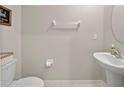 Neutral powder room featuring a pedestal sink and modern fixtures at 4403 Eternal Prince, Sun City Center, FL 33573