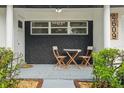 Close-up of a stylish front porch with seating, decor, and a unique brick design at 4609 S Lois Ave, Tampa, FL 33611