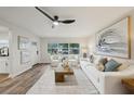 Comfortable living area with white seating, wood-look flooring, and ample natural light at 4609 S Lois Ave, Tampa, FL 33611