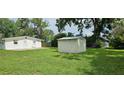 Large backyard with a storage shed, ideal for outdoor activities and storage at 4754 17Th St, Zephyrhills, FL 33542
