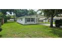 Quaint single-story home with a spacious front lawn and convenient carport at 4754 17Th St, Zephyrhills, FL 33542