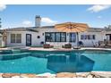 Backyard pool and patio area with lush landscaping, lounge furniture, and spa at 511 Island Way, Clearwater Beach, FL 33767