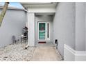 Inviting home entrance features a charming courtyard with decorative stone and covered doorway at 5117 Whispering Leaf Trl, Valrico, FL 33596