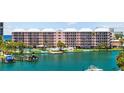 Waterfront condo featuring balconies, a boat dock, pool, and tennis courts for a resort-style living experience at 5445 Gulf Blvd # 210, St Pete Beach, FL 33706