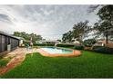 Backyard pool with brick surround and seating area, perfect for outdoor entertaining at 5919 35Th N Ave, St Petersburg, FL 33703