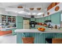 Retro kitchen featuring ample counter space, wood plank accents, and plenty of cabinet storage at 625 Fayette S Dr, Safety Harbor, FL 34695