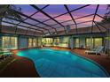 A serene screened-in pool offers a tranquil escape with ample lounge space and outdoor amenities at 625 Fayette S Dr, Safety Harbor, FL 34695