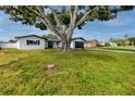 Well-maintained single-story house with a large front yard and a mature tree at 6920 13Th N Ave, St Petersburg, FL 33710