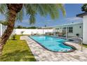 Backyard swimming pool with an outdoor seating area, perfect for relaxation and entertaining at 6920 13Th N Ave, St Petersburg, FL 33710